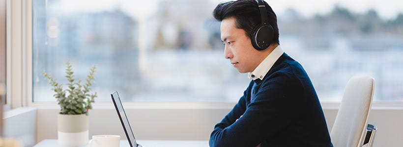 A person attending an online conference from his home.