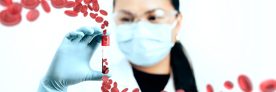 Scientist holding a blood sample in a test tube.